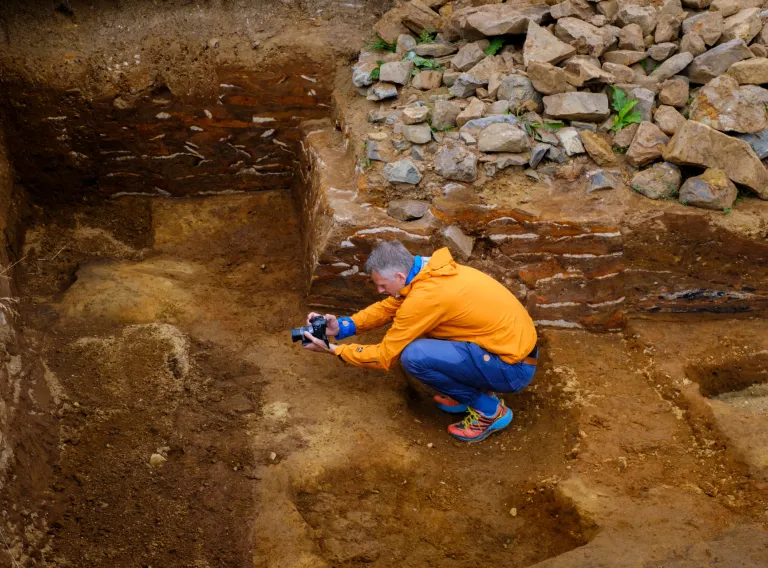 A man digging in historical archaeology place