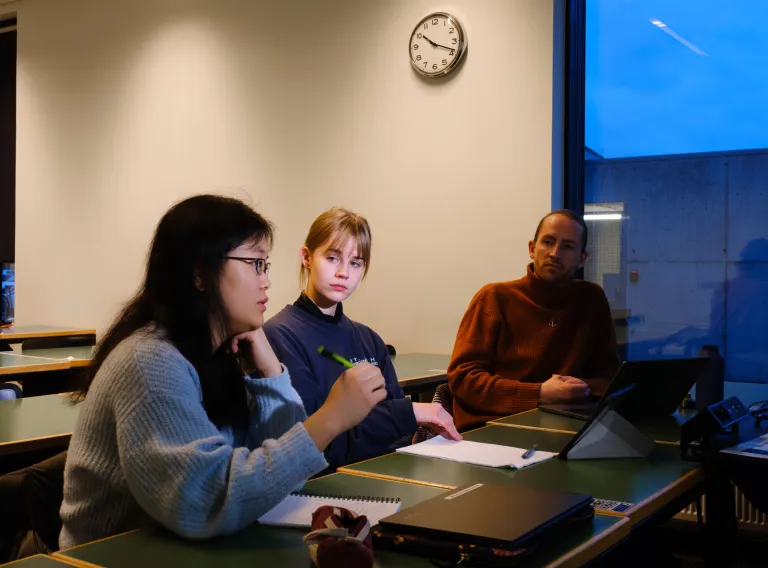 Three students in a classroom.