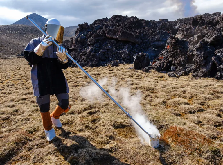Earth Sciences students taking sample from fresh lava. 