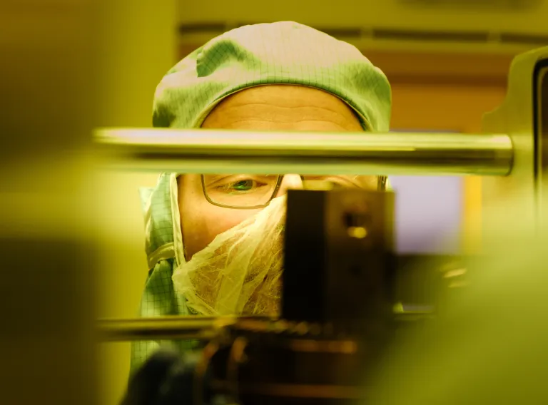 A student examines a sample under a microscope.