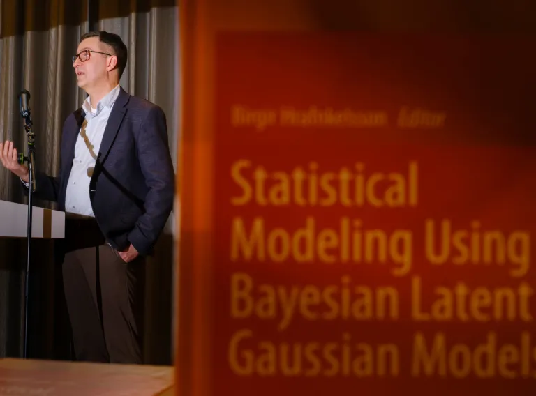 Man presenting book about Statistical Modeling