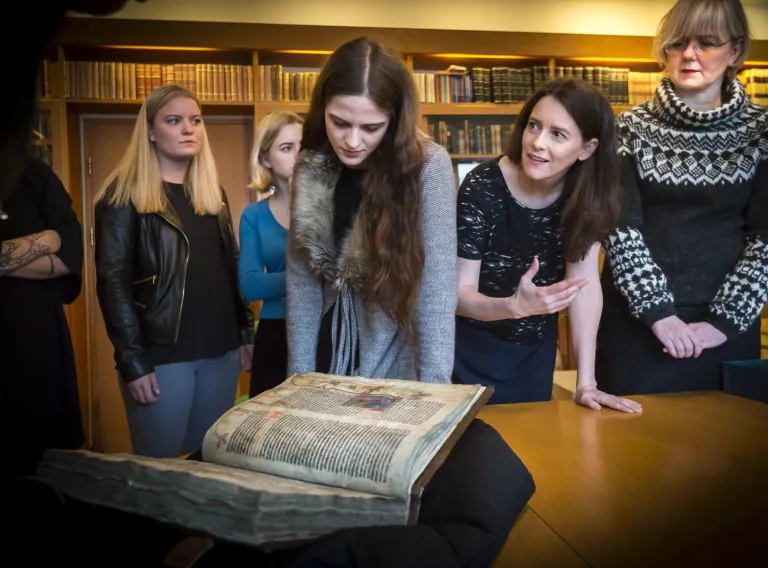 People looking at an old Manuscript