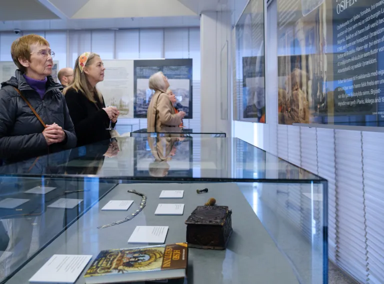 People looking at posters regarding to research in Anthropology.