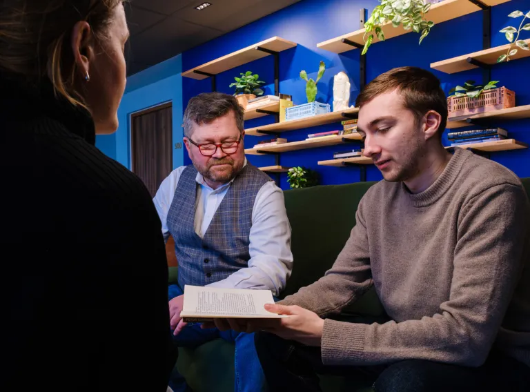 Teacher and student looking at a book