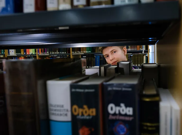 Student and books at the library