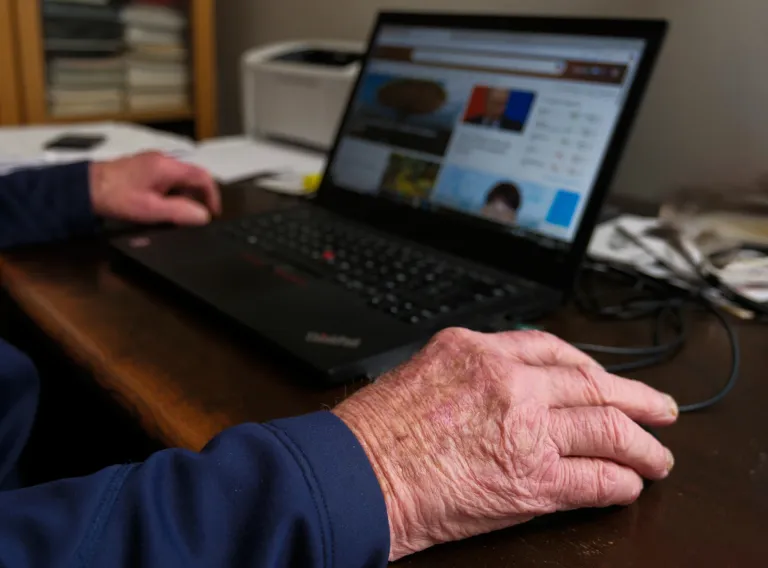 An older person using the computer.