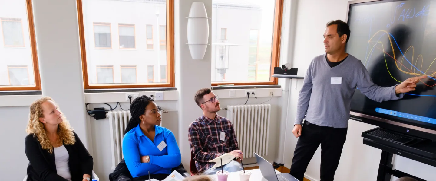 Doctoral student presenting his studies to other students