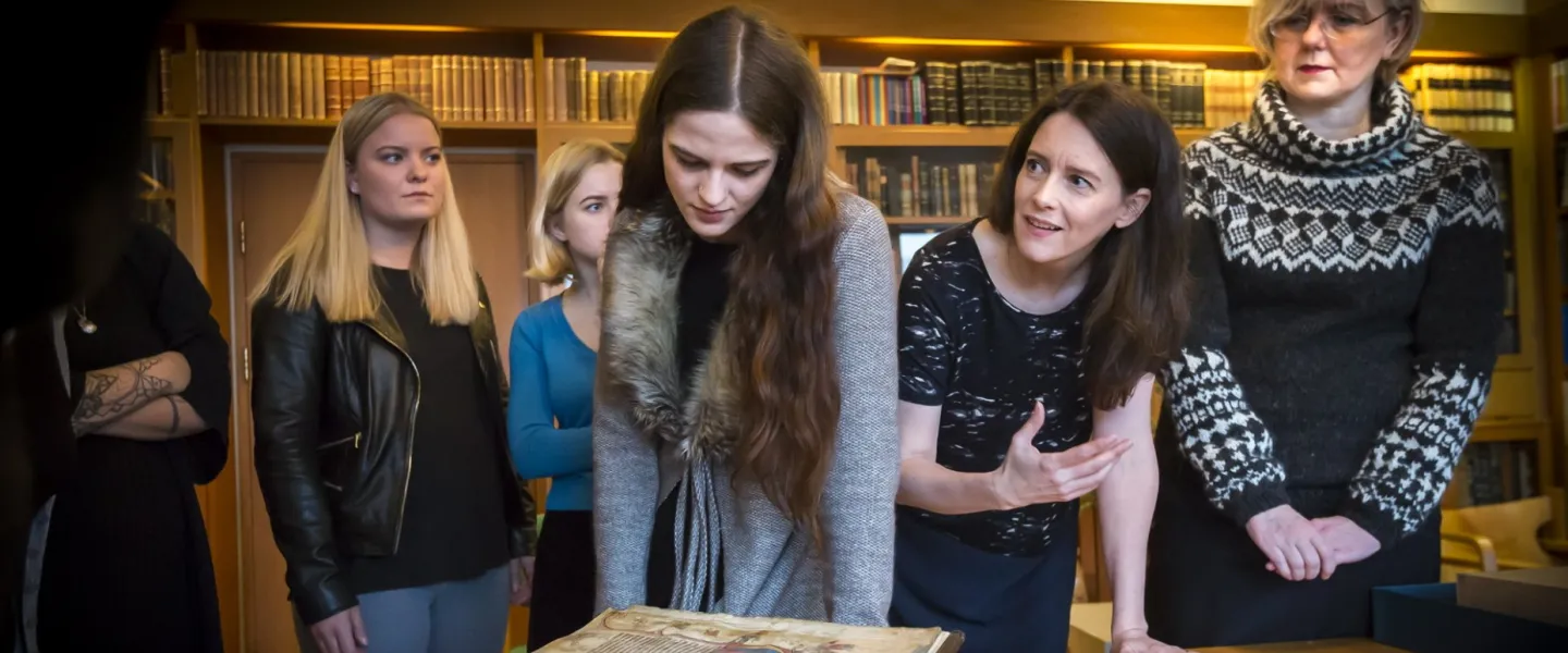 People looking at an old Manuscript