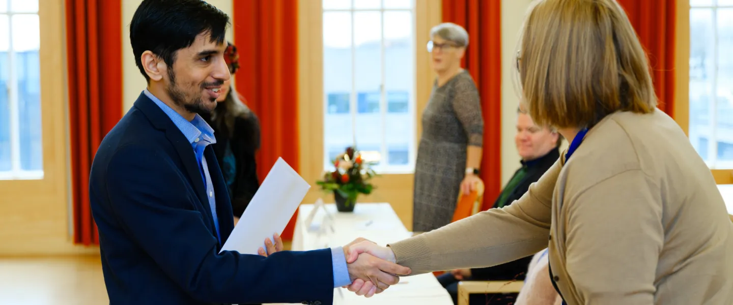 Student receiving its diploma