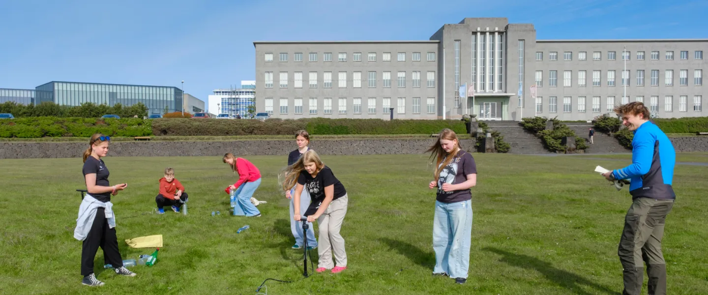 Students in the University of Youth out on the field outside the university's Main Building.