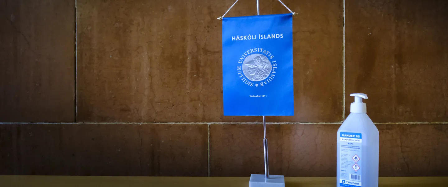 Covid, sanitizer, flag with University of Iceland logo