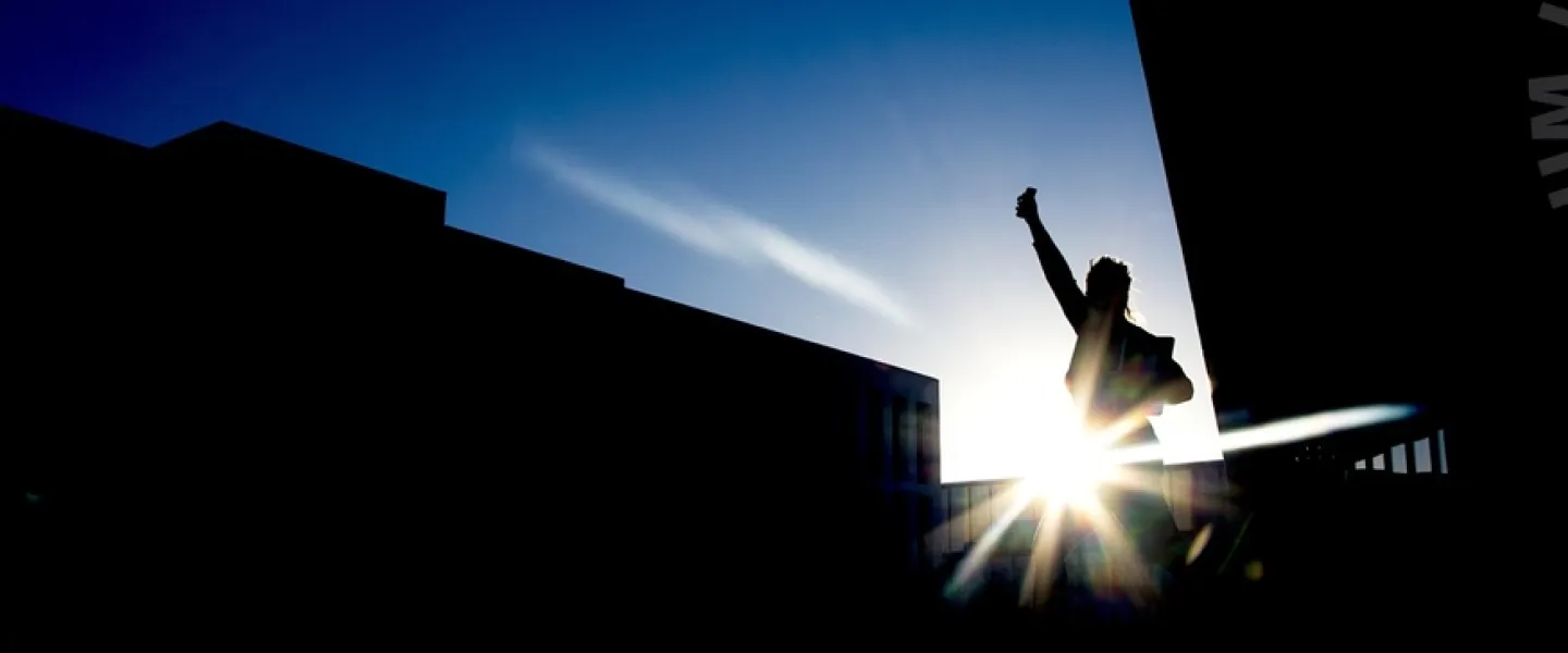 Silhouette of a person outside Lögberg and University centre