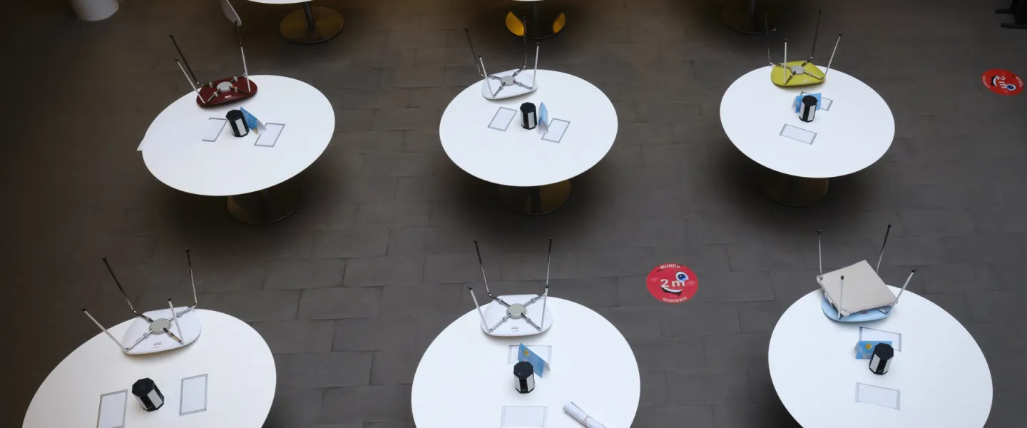 Empty chairs at empty tables in Gimli