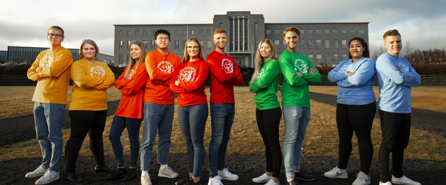 Students in colorful t-shirts, outside of University of Iceland Main building