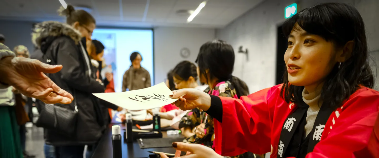 Woman writing a japanese letter, on the Japan festival in University of Iceland
