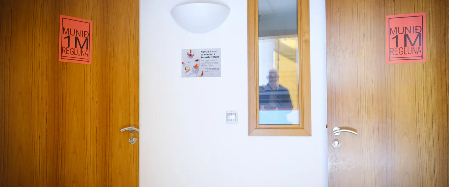 Doors with signs during covid-19 pandemic, reminding people of the 1 meter rule