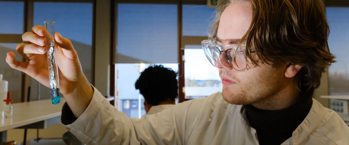 Student in chemistry with a test tube