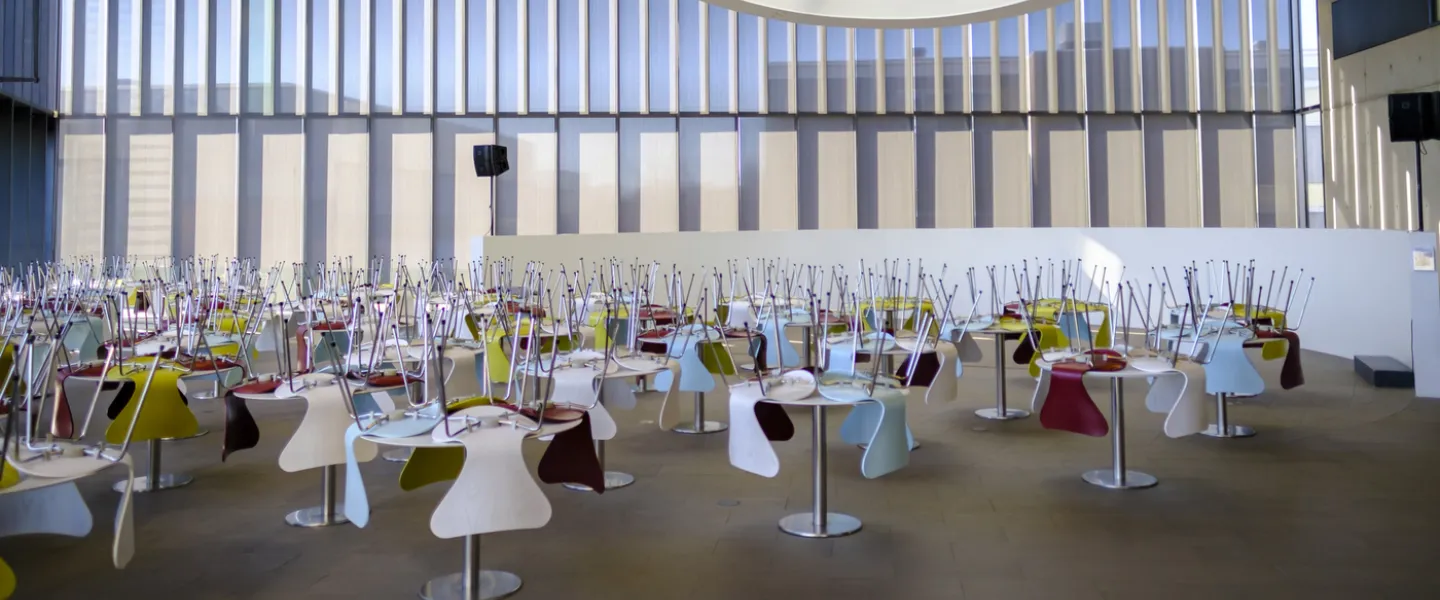 Empty chairs at empty tables at University centre
