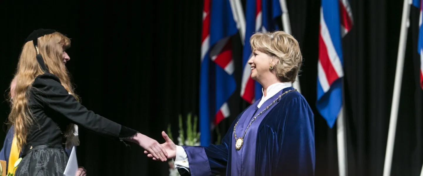 Kristín Ingólfsdóttir, rector of the University of Iceland at a graduation ceremony, congratulating one of the candidates