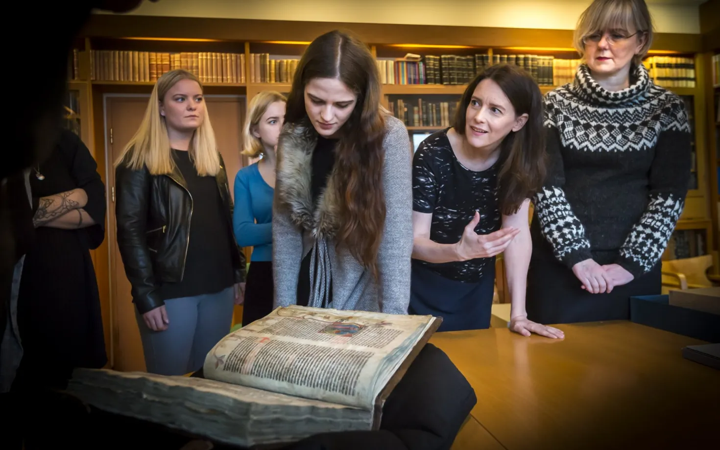 People looking at an old Manuscript