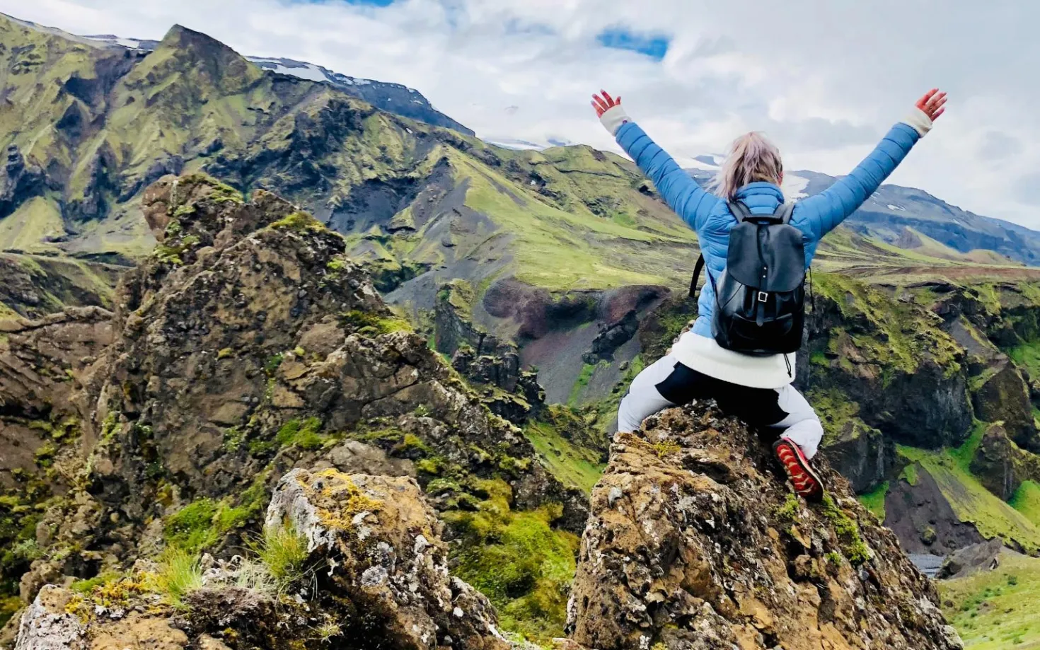 Woman on peak of a mountain
