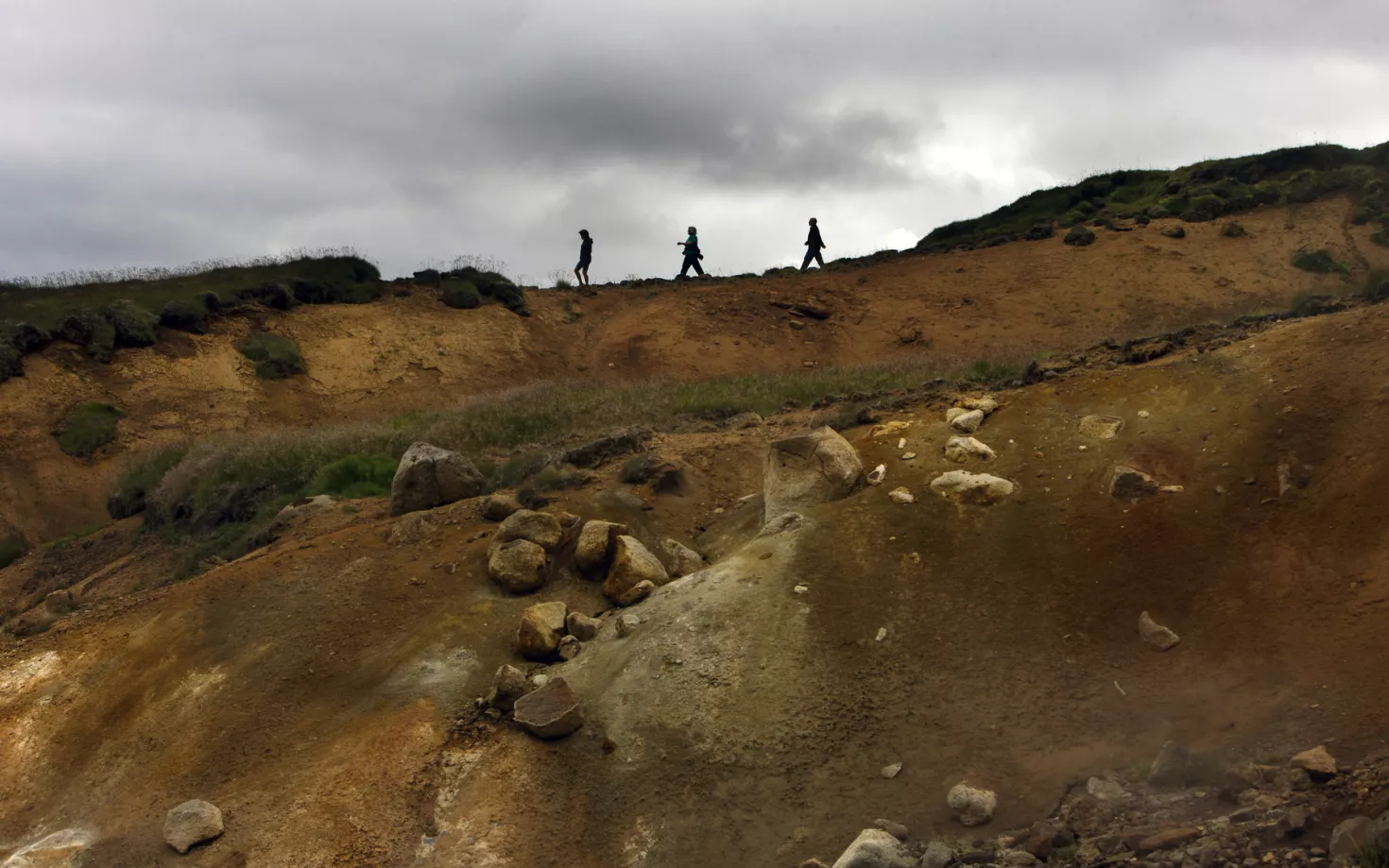 Three persons walking out in the wild nature