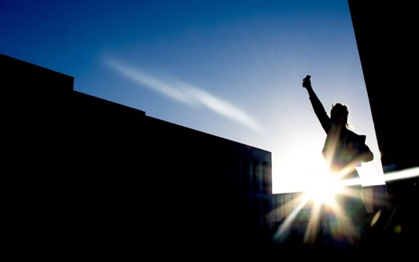 Silhouette of a person outside Lögberg and University centre