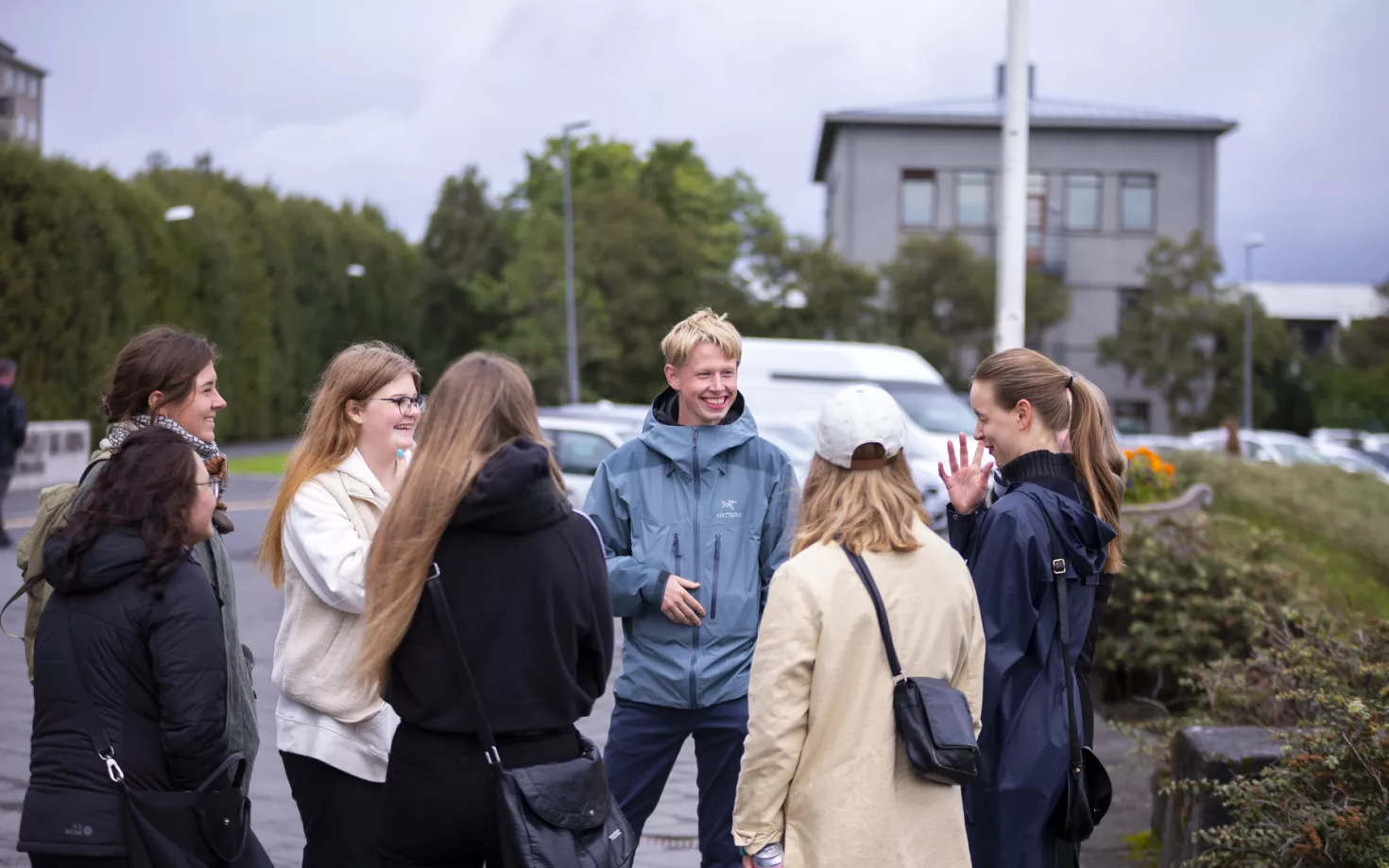 People standing outside University of Iceland Main building. Setberg in the Background