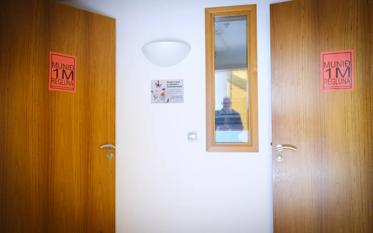 Doors with signs during covid-19 pandemic, reminding people of the 1 meter rule