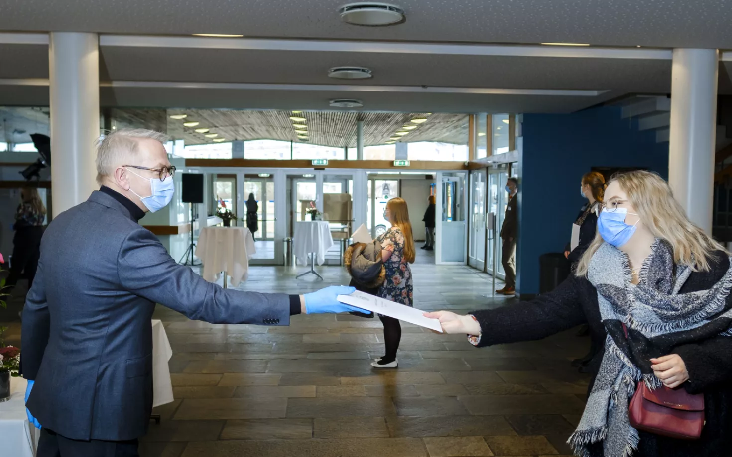 Graduation from University of Iceland during Covid-19 pandemic. People wearing face masks.