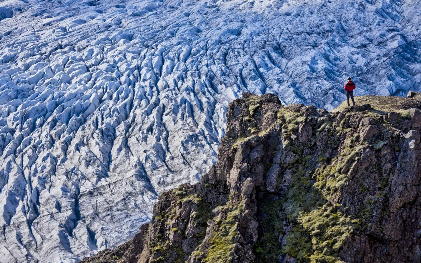 Kieran Baxter standing above a glacier