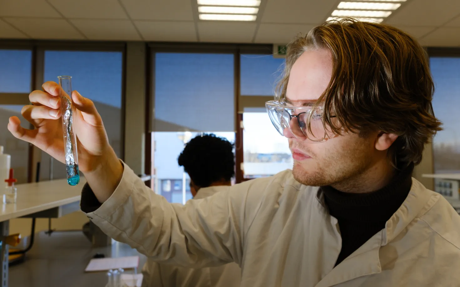 Student in chemistry with a test tube