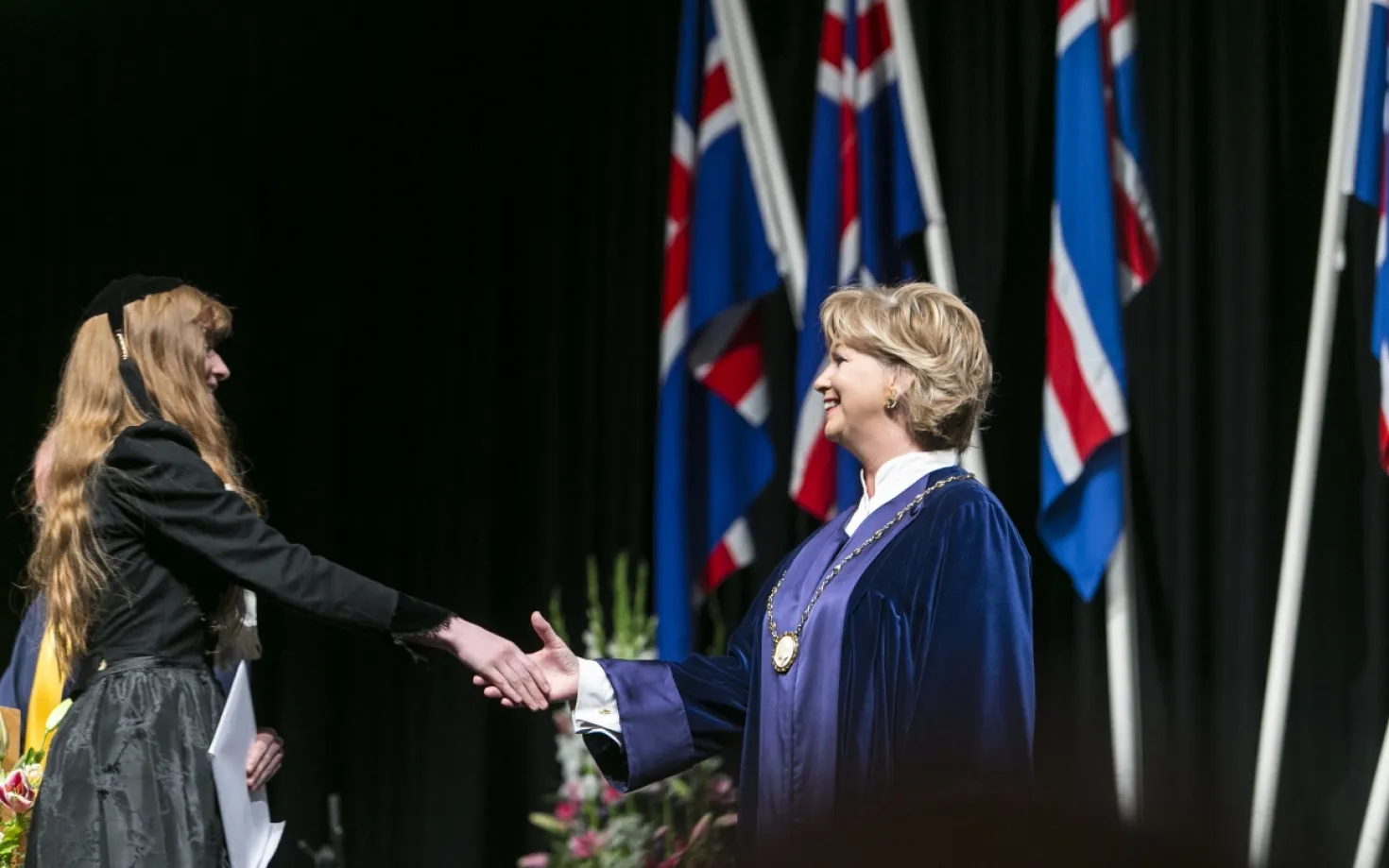 Kristín Ingólfsdóttir, rector of the University of Iceland at a graduation ceremony, congratulating one of the candidates