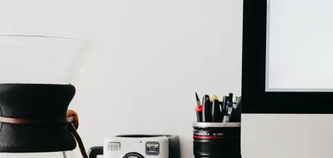 Desk with coffee and pens