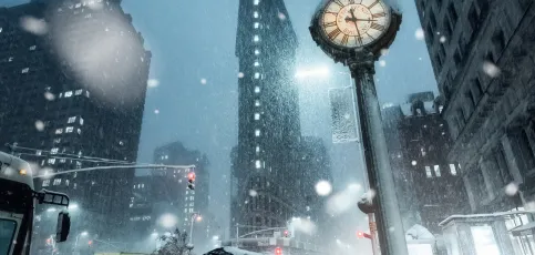 Road with cars in the winter with snow falling from the sky