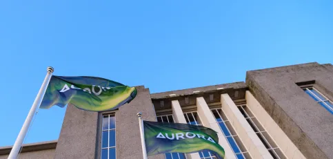 Set up. Two students in  in violet light. A fire burns in the background