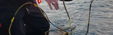 Ragnar director fishing up small research submarine from a boat.