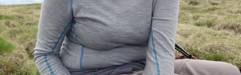 Woman holding gently on to a duck that is being tagged