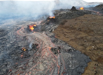 The Fagradalsfjall eruption site viewed from above. The photo shows lava emanating from multiple vents. Tourists for scale. Photo: drone image by Alina V. Shevchenko and Edgar U. Zorn, GFZ Germany.
