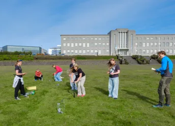 Students in the University of Youth out on the field outside the university's Main Building.