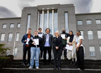 The graduating mentor cohort standing outside the Main Building.