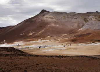 Tourists exploring geysers.