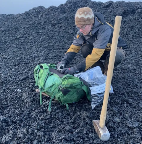 Simon Matthews collecting samples of the new lava and tephra in January 2024.