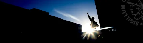 Silhouette of a person outside Lögberg and University centre