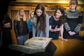 People looking at an old Manuscript