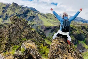 Woman on peak of a mountain