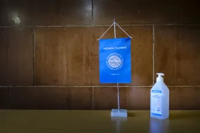 Covid, sanitizer, flag with University of Iceland logo