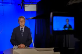 Jón Atli Benediktsson, rector of the University of Iceland, in front of a camera