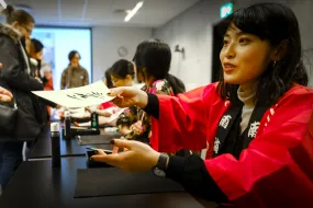 Woman writing a japanese letter, on the Japan festival in University of Iceland