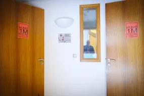 Doors with signs during covid-19 pandemic, reminding people of the 1 meter rule